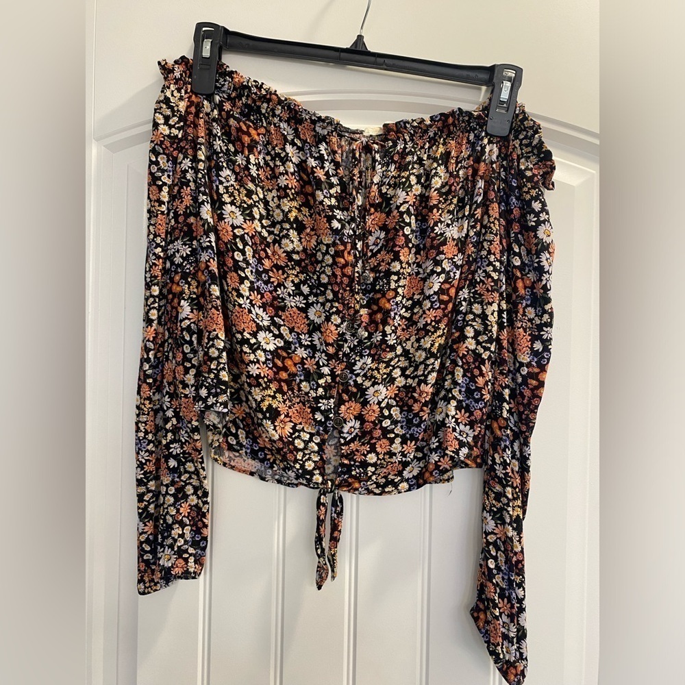 Open shoulder, button up, tie at top and bottom floral peace style shirt. Boho